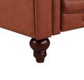 Tan cognac Chesterfield sofa dark walnut turned wooden leg close-up showing rounded spindle shape