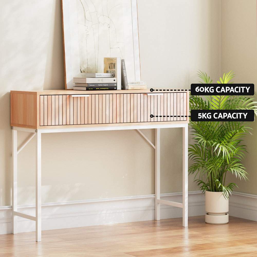 Console table in room setting with capacity labels: 60kg surface and 5kg drawer, books and artwork displayed on top