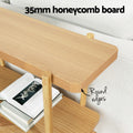 Feature shot of 35mm honeycomb board top shelf with round edges callout, books on lower shelf beside white sofa