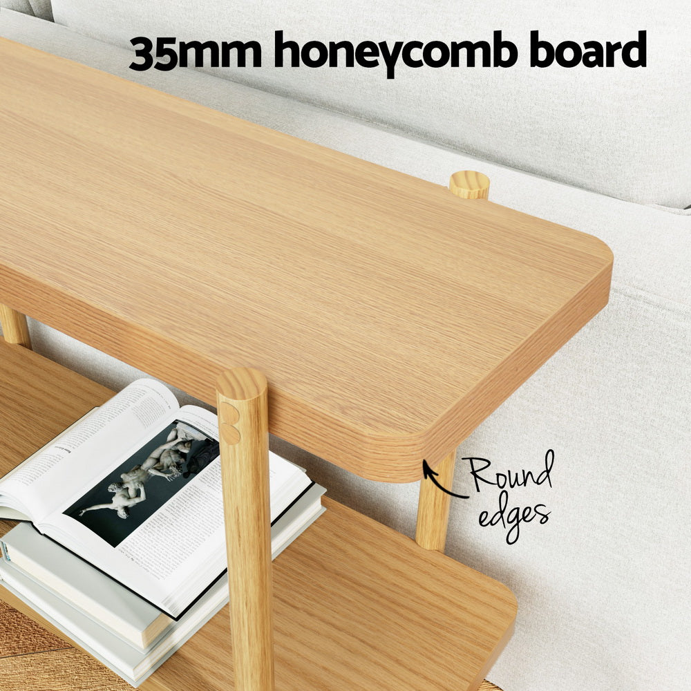 Feature shot of 35mm honeycomb board top shelf with round edges callout, books on lower shelf beside white sofa