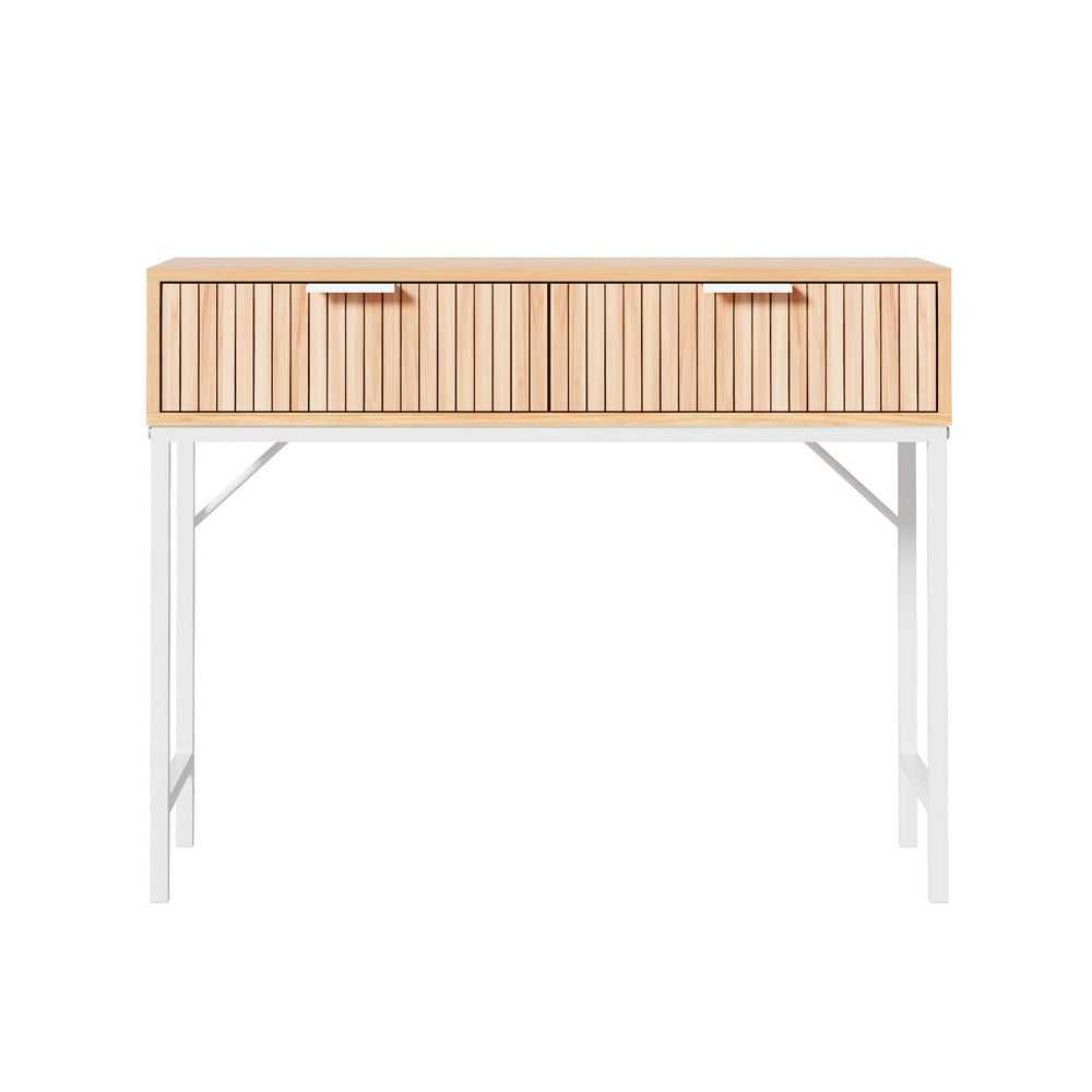 Console table front view: natural oak fluted two-drawer body with silver bar handles on white X-frame metal legs