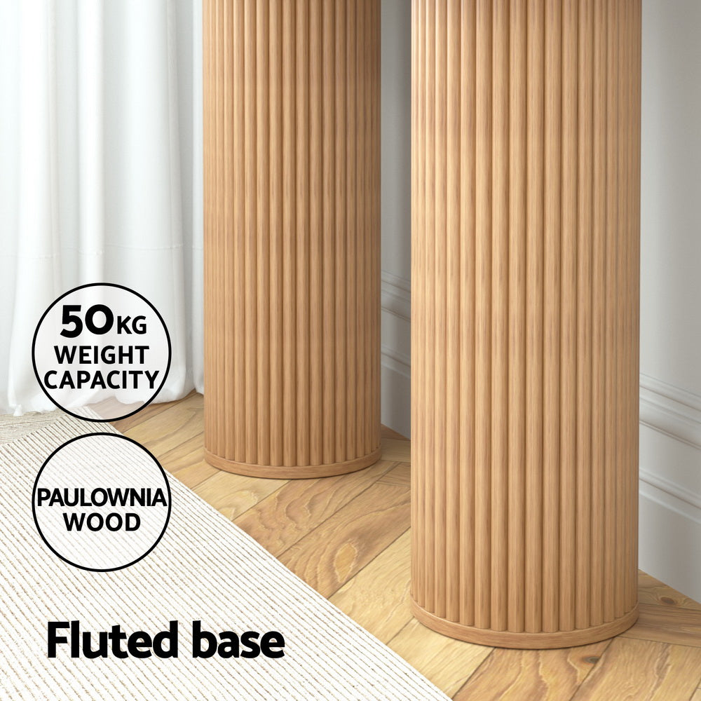 Close-up of two cylindrical fluted column bases with 50kg weight capacity and Paulownia wood badges, in room setting