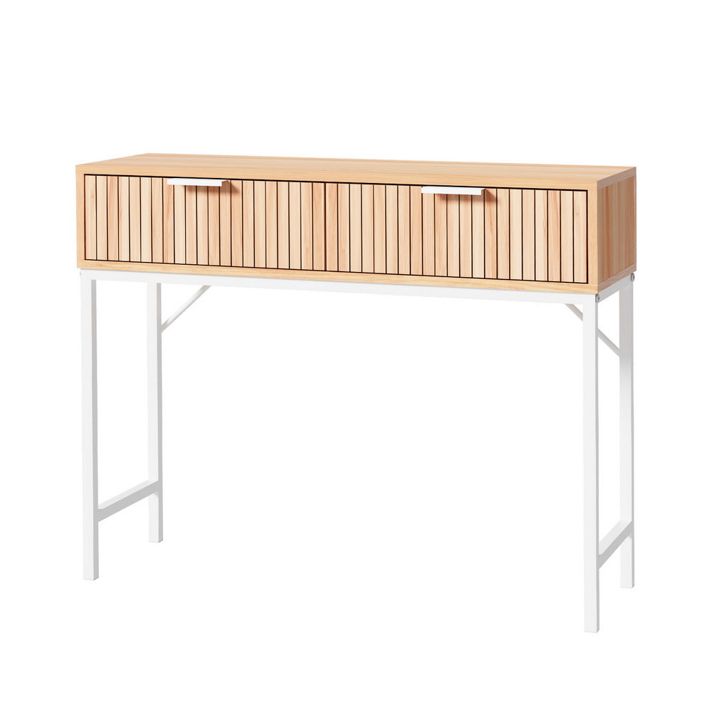 Console table with natural oak fluted two-drawer front and white metal X-frame legs, three-quarter angle on white background