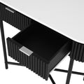 Close-up of open drawer showing black interior, silver bar handle, set within black fluted curved console body