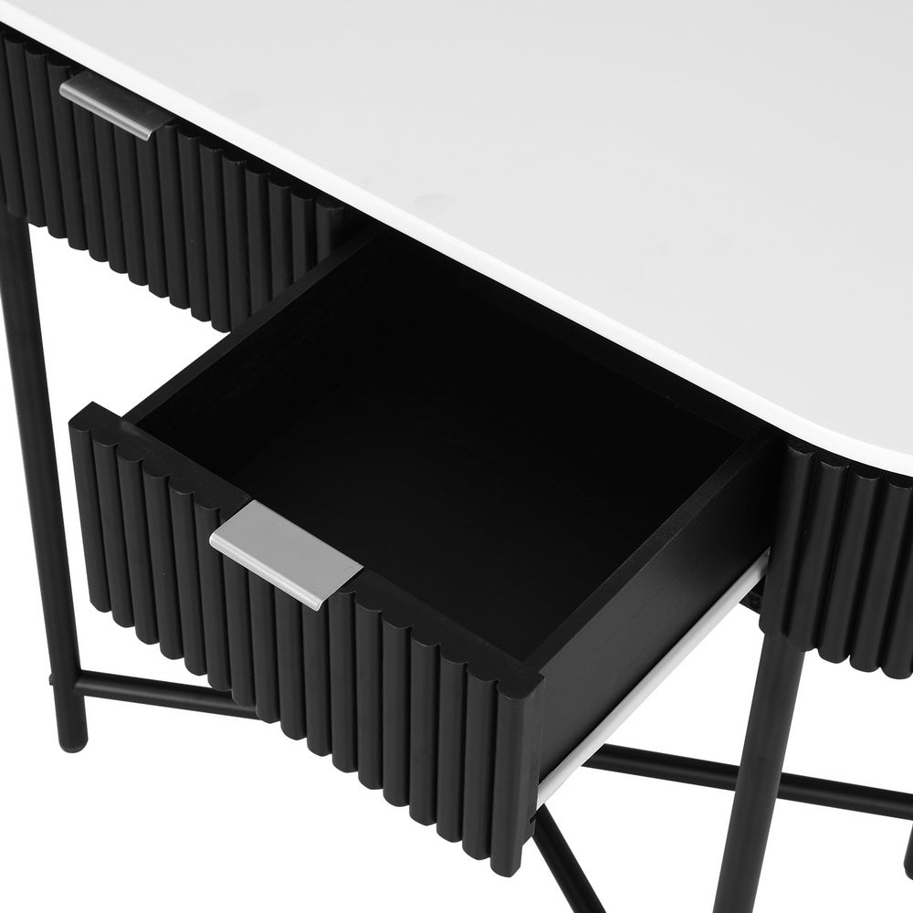 Close-up of open drawer showing black interior, silver bar handle, set within black fluted curved console body