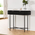 Console table with white oval top, black fluted drawer panel and black metal X-frame legs, in room near window