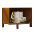 Close-up of corner bookcase bottom shelf with books, a round grid box, and a gold horse figurine on warm brown wood
