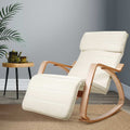 Cream ribbed fabric bentwood rocking recliner with extended footrest, lifestyle room with palm plant and wooden side table