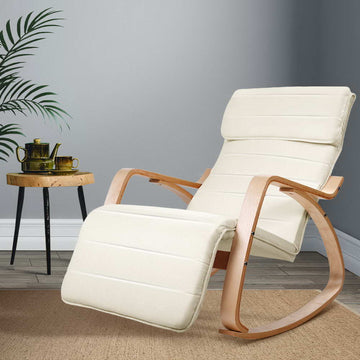 Cream ribbed fabric bentwood rocking recliner with extended footrest, lifestyle room with palm plant and wooden side table