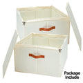 Two cream fabric shoe storage boxes open with lids showing internal dividers and orange leather handles on white background
