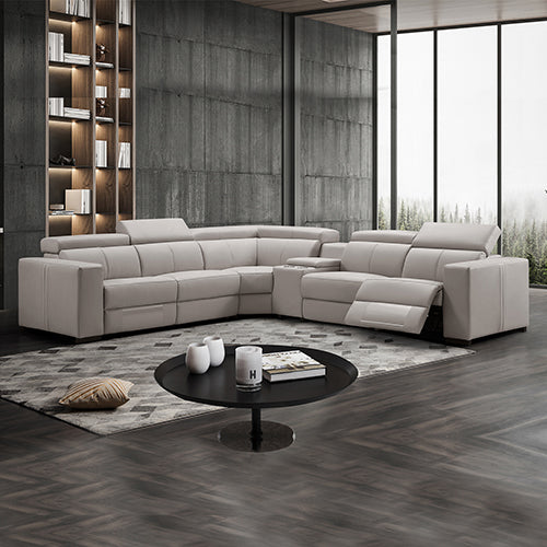 Cream leather L-shaped sectional recliner sofa in dark-toned living room with one footrest extended