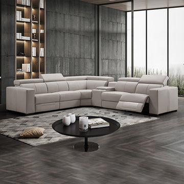 Cream leather L-shaped sectional recliner sofa in dark-toned living room with one footrest extended