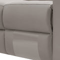 Close-up of cream leather recliner sofa padded backrest cushion with stitching and two-tone upholstery detail