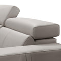 Close-up of cream leather recliner sofa adjustable articulating headrest with stitched upholstery detail