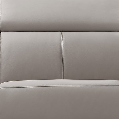Close-up of cream leather recliner sofa backrest surface showing two-panel stitched upholstery