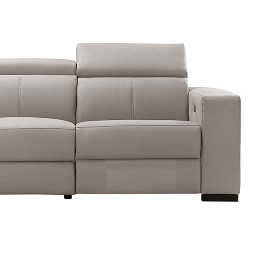 Close-up of cream leather recliner sofa end seat section showing padded headrest and seat cushion