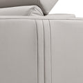 Close-up of cream leather recliner sofa outer side panel with vertical seam lines and base detail