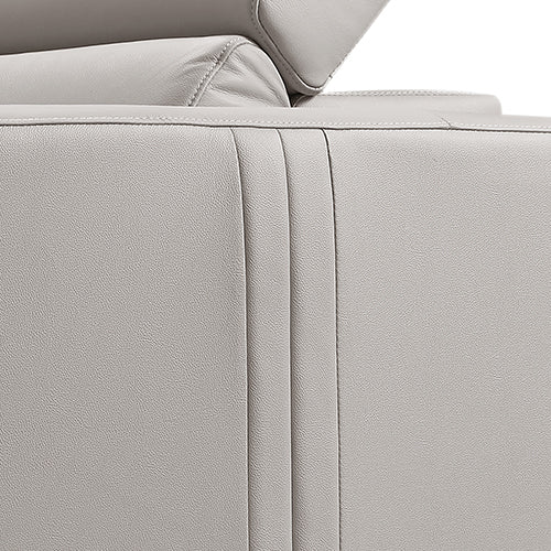 Close-up of cream leather recliner sofa outer side panel with vertical seam lines and base detail