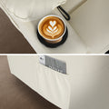 Cream PU recliner detail: cup holder with latte (top) and side pocket with magazine (bottom)