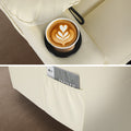 Cream tufted PU recliner detail: cup holder with latte (top) and side pocket with magazine (bottom)