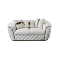 Cream velvet chesterfield 2-seater loveseat with gold-striped pillows and button tufting on white background
