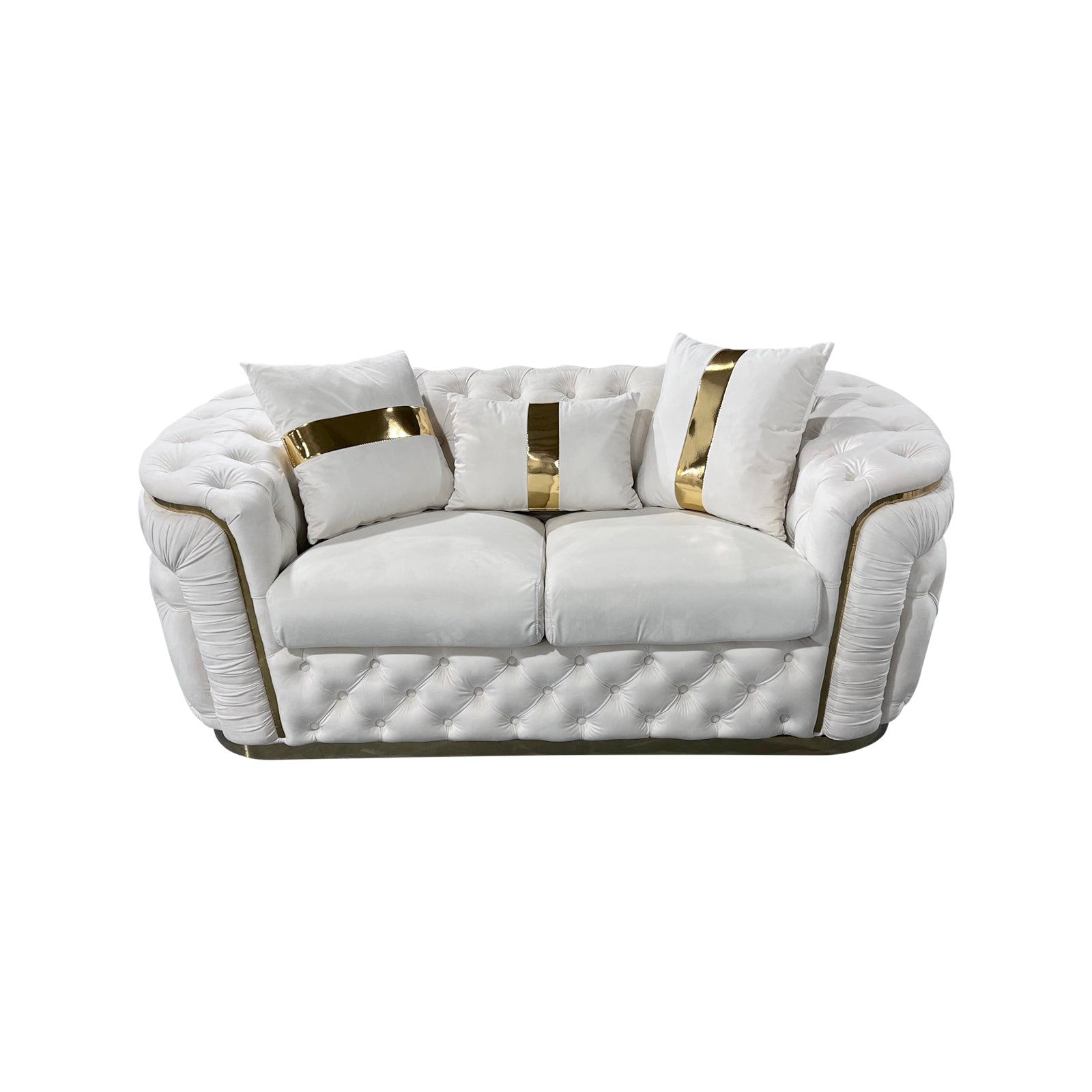 Cream velvet chesterfield 2-seater loveseat with gold-striped pillows and button tufting on white background