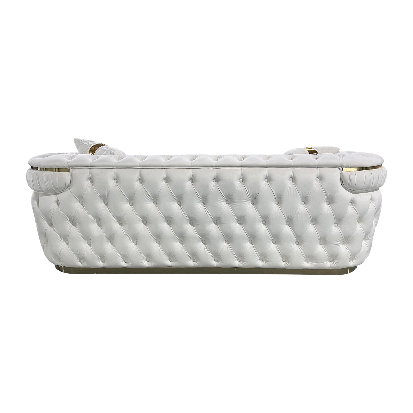 Rear view of cream velvet chesterfield 3-seater sofa showing button-tufted back and gold metal base trim