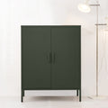 Dark green two-door metal locker cabinet with bar handles and louvre vents beside chrome floor lamp