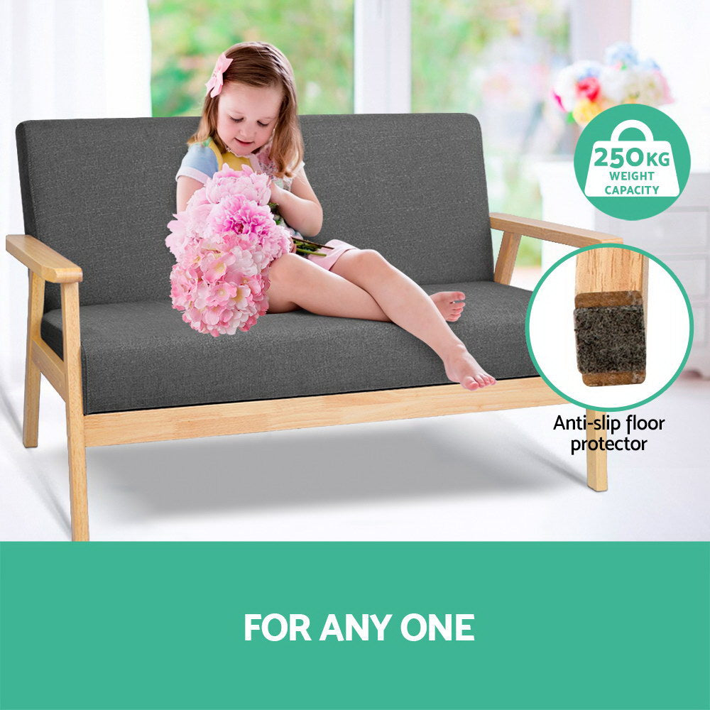 Child on dark grey two-seater sofa with pink flowers, 250KG weight capacity badge, anti-slip floor protector leg close-up