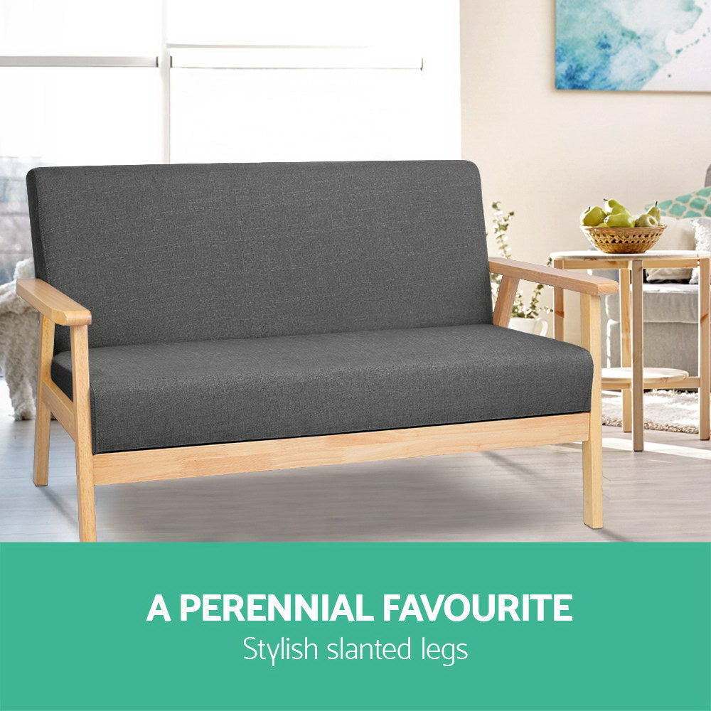 Dark grey fabric two-seater sofa in lifestyle dining room, text: A Perennial Favourite, Stylish slanted legs