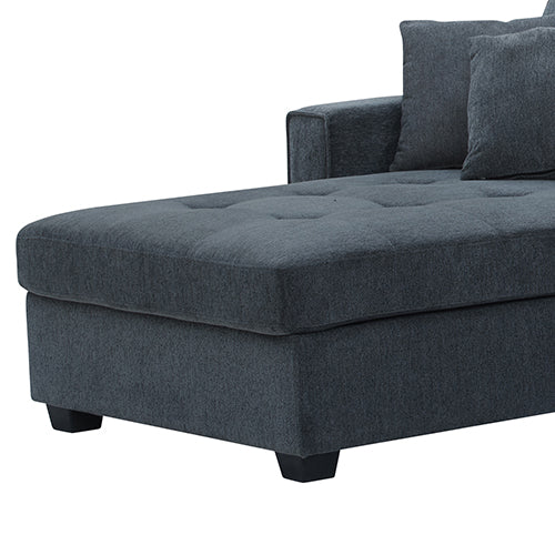 Dark grey chenille sectional chaise close-up showing tufted button seat cushion and black legs