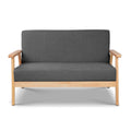Dark grey fabric two-seater sofa with solid natural wood frame and flat armrests, front view on white background