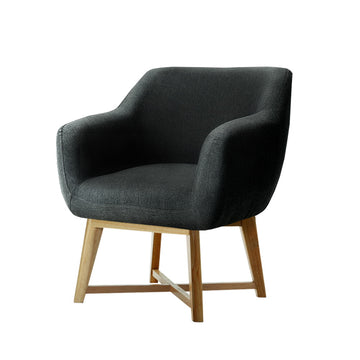 Dark charcoal fabric tub armchair with curved seat and natural wood legs with cross-brace, angle view on white background