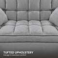 Dark grey chenille L-shaped sectional sofa in living room with fireplace and indoor plants