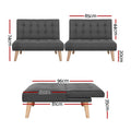 Dark grey tufted armless sofa bed with wooden legs viewed from front on white background