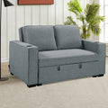 Dark grey Hoffman sofa bed in styled living room with floor lamp and palm plant
