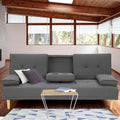 Dark grey fabric sofa bed with cupholder in modern living room with timber ceiling and floor