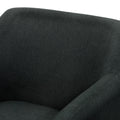 Close-up of dark charcoal woven fabric texture on back and arm of tub armchair