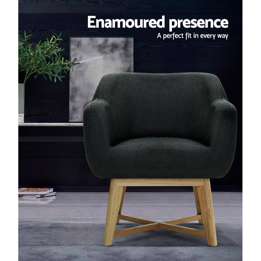 Dark charcoal tub armchair in dark lifestyle room with plant, text: Enamoured presence, A perfect fit in every way