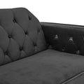 Close-up of dark grey velvet sofa bed tufted back and armrest from overhead angle