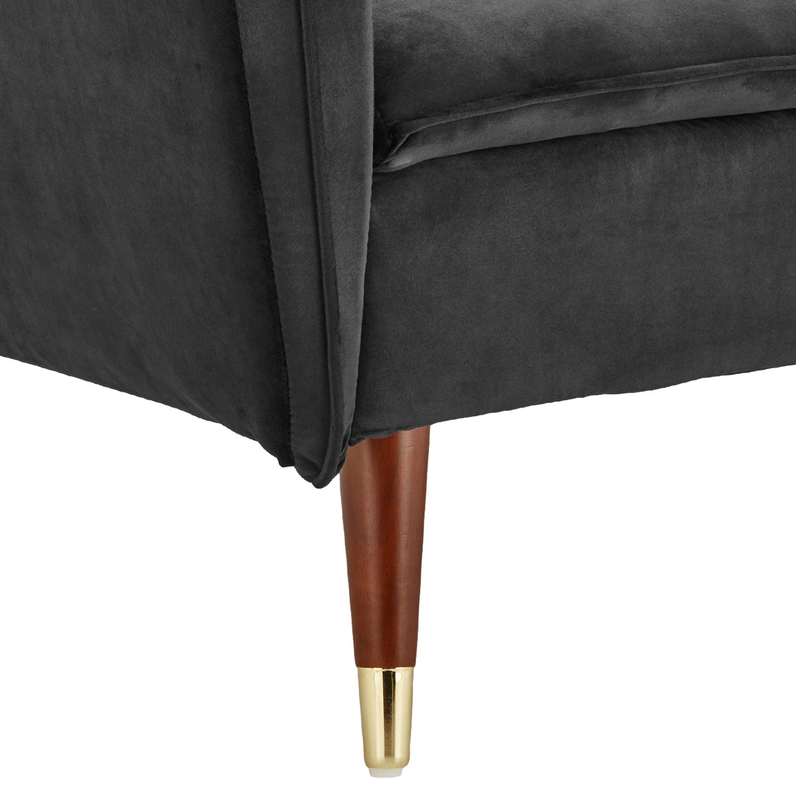 Close-up of dark grey velvet sofa bed angled arm and tapered walnut leg with gold tip detail