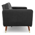 Side profile of dark grey velvet tufted sofa bed showing angled arm and tapered walnut leg