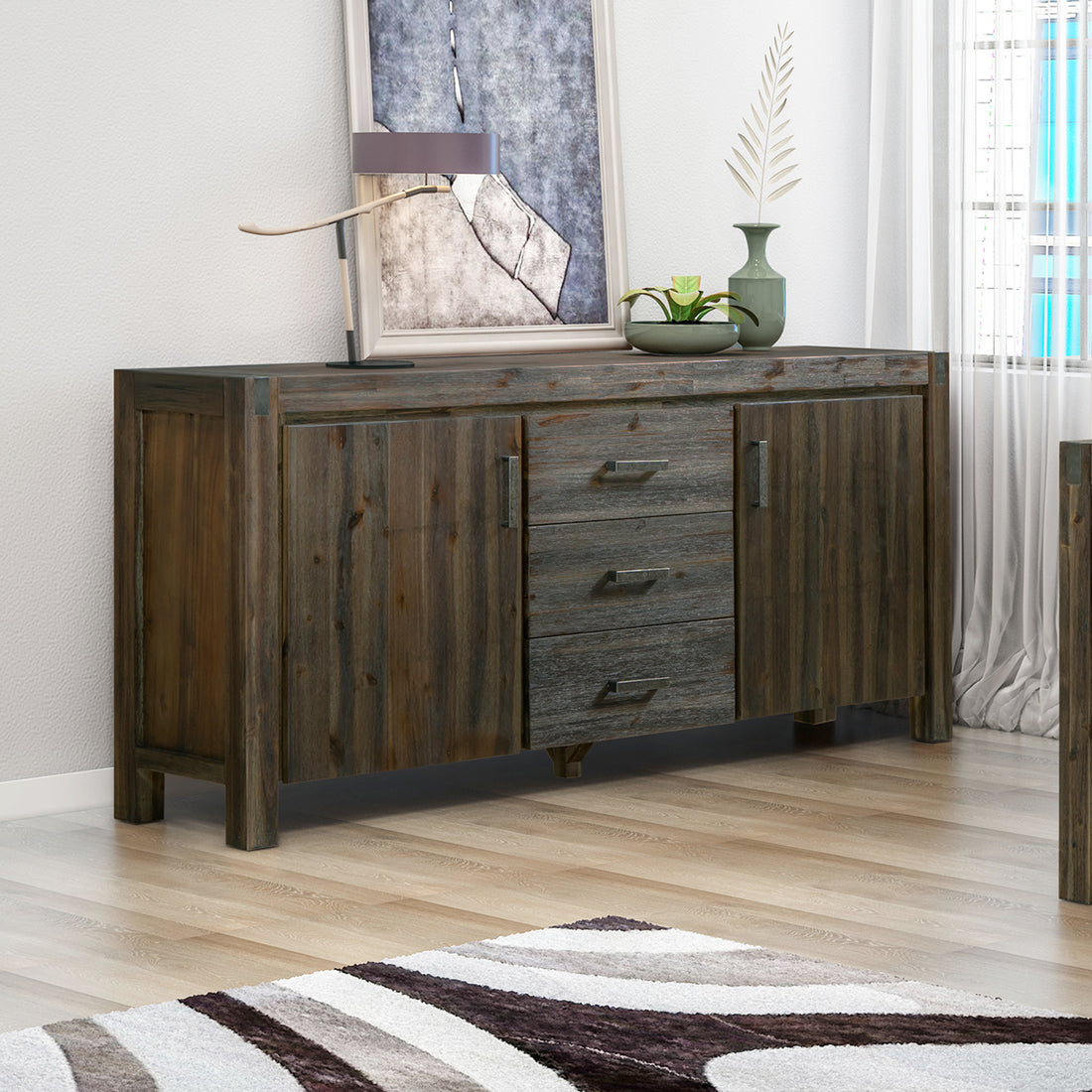 Dark grey distressed wood sideboard with two side doors and three central drawers with metal pulls in living room setting
