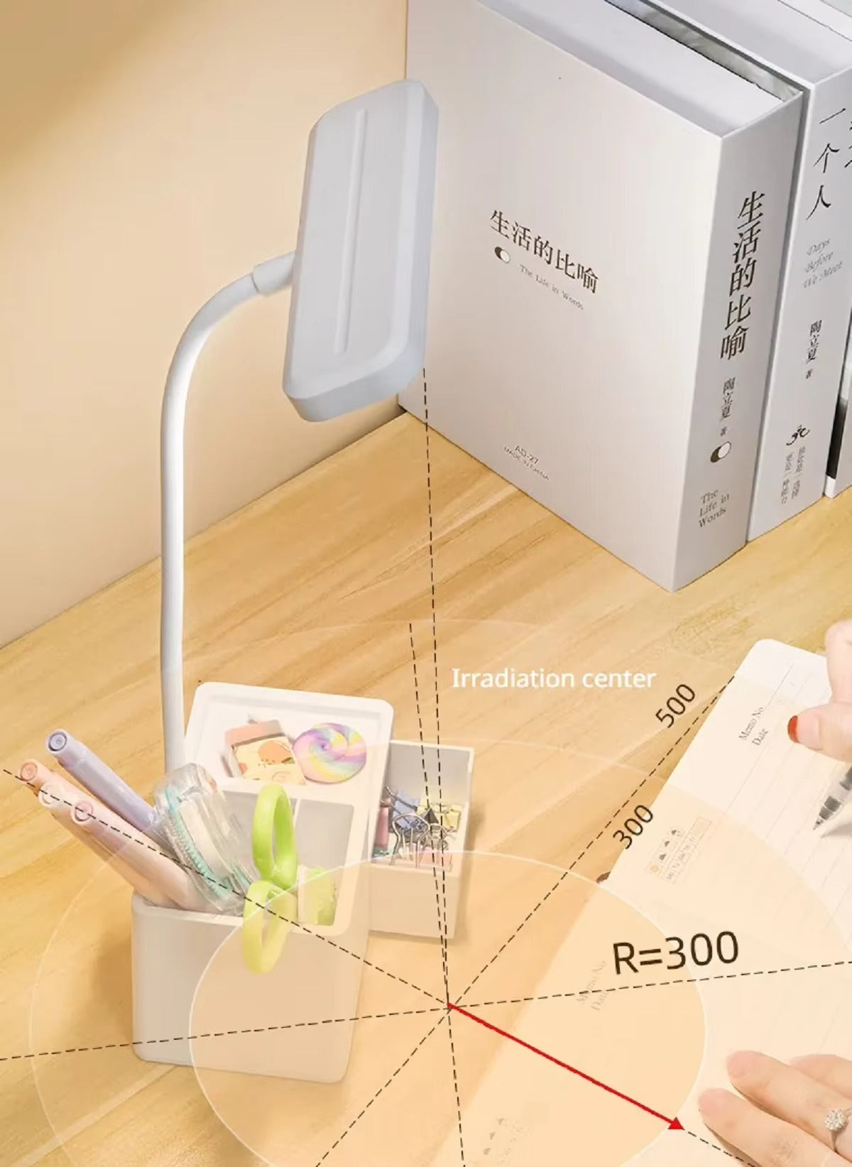 White flexible neck desk lamp with organizer base showing irradiation range diagram R=300 on wooden desk