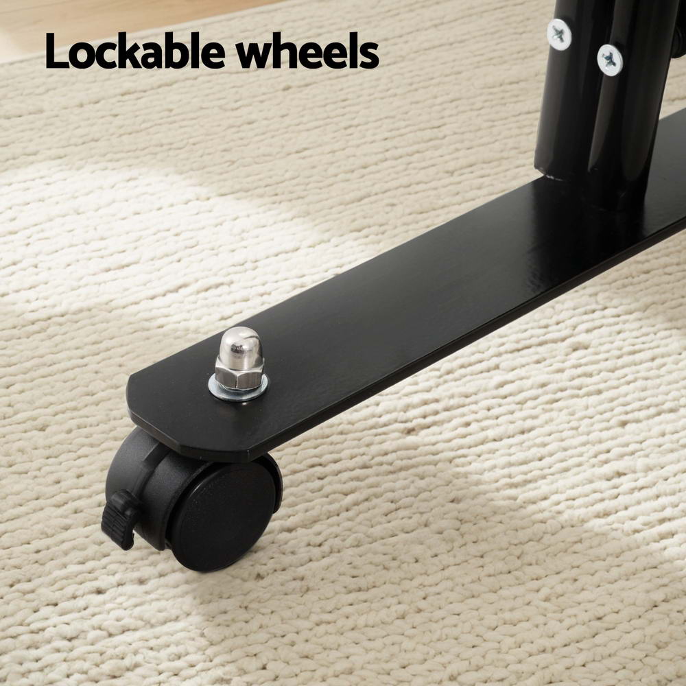 Room divider lockable caster wheel close-up on cream rug with black metal T-bar base and silver acorn bolt