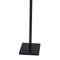 Close-up of flat black square metal base of dual-arm floor reading lamp with black pole on white background