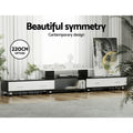 Black and white extendable TV unit 220cm option in bright living room with artwork and decorative items on top