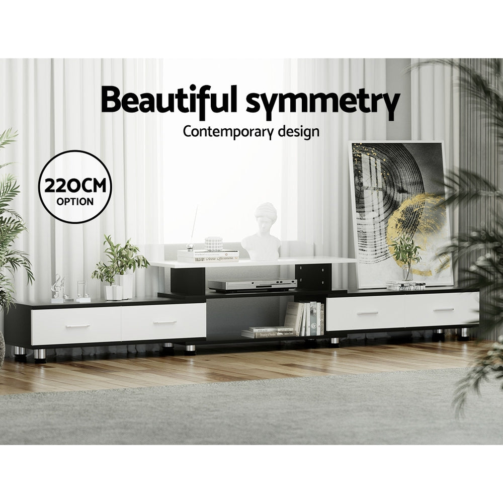 Black and white extendable TV unit 220cm option in bright living room with artwork and decorative items on top
