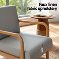 Close-up of grey armchair seat by window labelled 