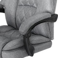 Close-up of grey fabric armrest pad with black pivot armrest mechanism against diamond-stitch back on white background
